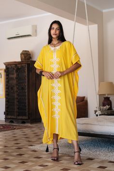 **Note : The kaftan in the video is a different color of the same kaftan and is shown to display the cut, fit, and fabric. You will receive the kaftan in the pictures.** An elegant Moroccan caftan will make you feel like African royalty. It's extremely elegant with a dash of classy cotton embroidery in the front. Ideal for plus size women as well. Made of extremely soft fabric to make you feel free and beautiful at the same time.  This Kaftan is ideal to wear for any casual occasion. Whether tak Yellow Chikankari Embroidery Kaftan, Traditional Yellow Kaftan For Eid, Yellow Maxi Length Kaftan For Spring, Yellow Bohemian Kaftan For Festive Occasions, Yellow Bohemian Kaftan For Festive Season, Yellow Maxi Dress For Eid, Long Yellow Dress For Festivals, Long Yellow Dresses For Festivals, Long Yellow Festival Dress