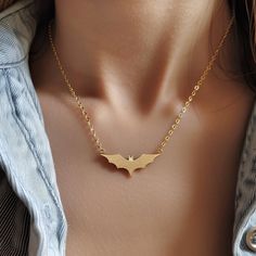 14k Gold Bat Charm Necklace, Gold Halloween Bat Necklace, Tiny Gold Bat Necklace, Spooky Bat Necklace, Dainty Halloween Bat Charm Necklace 🌺Item Details🌺 Item Name : Halloween Bat Necklace Metal : 925 Silver Necklace Size  : 16 Inch Pendant Size : 25*20MM                                                                  🌊 *About Us: Natural World Jewelry* 🐚 At Natural World Jewelry, we're passionate about bringing the serene beauty of the ocean to your everyday life. Our artisanal jewelry pie Halloween Clavicle Chain Jewelry Gift, Halloween Gift Clavicle Chain Jewelry, Gothic Gold Necklace With Clavicle Chain, Adjustable Chain Jewelry For Halloween Party, Gold Necklace For Halloween Party, Handmade Vampire Necklaces For Halloween, Halloween Party Jewelry With Adjustable Chain, Halloween Party Pendant Jewelry, Spooky Halloween Jewelry For Costume Party