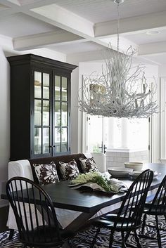 a dining room table with chairs and a chandelier