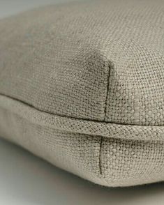 a close up view of a pillow on a white surface with no one around it