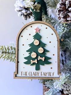 Add a touch of elegance to your holiday décor with our timeless three-layered Christmas Ornament. Crafted in a graceful arch shape, this 4.6" x 3.5" keepsake features a white backer, beautifully laser engraved, serving as the perfect canvas for each family member's name. It can accommodate up to 8 names. A stained maple wood frame crowns the ornament, surrounding a muted forest green acrylic Christmas tree with a charming red and white vintage-style star--a nod to classic holiday traditions. Each family member's name is carefully laser engraved onto individual solid maple wood pieces, creating a personalized and heartwarming touch for every household. Each ornament comes ready to hang with jute or suede string, adding a rustic and classic feel--no ribbon is included unless otherwise noted. Acrylic Christmas Tree, Personalized Family Ornaments, Tree Family, Arch Shape, Family Christmas Ornaments, Cnc Projects, Style Star