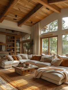 a living room filled with lots of furniture next to large windows on top of a wooden floor