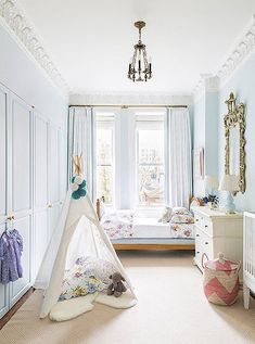 a child's bedroom with a teepee tent in the corner