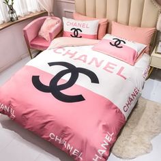 a chanel bed with pink and white sheets, pillows and pillow cases on it