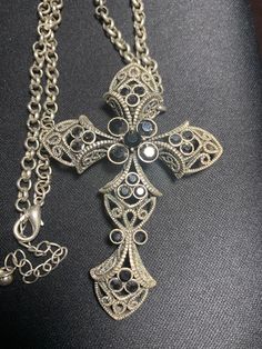 "Vintage base metal ornate cross necklace.  Black stones set in a filagree cross.  Cross is 3\" high, 2\" across.  Total length of chain is 18\" with a 2 adjustable length lobster closure." Adjustable Chain Metal Cross Necklace, Ornate Cross Necklace With Intricate Design, Elegant Metal Crucifix Cross Necklace, Costume Jewelry Metal Cross Pendant, Costume Jewelry Cross In Metal, Vintage Metal Cross Necklace, Bohemian Cross Metal Jewelry, Bohemian Metal Cross Jewelry, Metal Cross Necklace