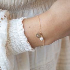 Elevate your everyday elegance with our Initial and Pearl Bracelet. Personalized with your chosen initial and adorned with a lustrous pearl, this bracelet exudes timeless sophistication. A perfect blend of classic style and modern minimalism, it's a must-have accessory for any occasion. …………………………………. Details: Available in 14K Gold Filled or Sterling Silver Pendant is Swarovski Pearl measuring 6mm Disc is 14k Gold Filled hand-stamped measuring 9mm Waterproof and can be worn all the time Average Bracelet Initial, Everyday Elegance, Bracelet Dainty, Classy Jewelry, Modern Minimalism, Initial Bracelet, Personalized Bracelets, Swarovski Pearls, Sterling Silver Pendant