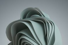 an abstract sculpture made out of paper on a gray background with room for text or image