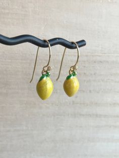 These dainty lemon earrings are made of the following: (1) Gold plated yellow epoxy lemon charm (13.5 x 7.5 mm) (2) Gold plated or 14KGF earring hooks ✏️ Please choose your desired earring hooks 🍋OTHER STYLE 🍋 Stud Earrings -> https://www.etsy.com/listing/905059870 🍋NECKLACE 🍋 → https://www.etsy.com/listing/597533538 🍋 LEMON SLICE EARRINGS 🍋 -> https://www.etsy.com/listing/720904838 【BEFORE PURCHASE, PLEASE NOTE THE FOLLOWINGS】 ☆ VAT, GST and any other taxes from your country are NOT Yellow Enamel Round Jewelry, Classic Yellow Earrings For Gift, Classic Yellow Earrings As Gift, Yellow Gold Enamel Dangle Earrings, Handmade Lemon Color Dangle Jewelry, Yellow Gold Enamel Dangle Jewelry, Classic Yellow Dangle Jewelry, Yellow Enamel Jewelry For Gift, Nickel-free Yellow Gold Enamel Earrings