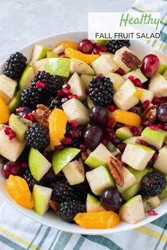 a white bowl filled with fruit and nuts