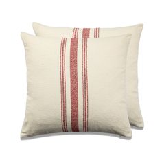 two red and white striped pillows sitting next to each other