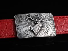 The Mesa Elk by Comstock Heritage is a Sterling silver "Mesa" shape square buckle featuring hand engraving around a hand cast Sterling silver elk figure. Measures 2" x 3" Fits up to a 1 ½" belt strap Alligator Belt, Ostrich Legs, Leg Belt, Leather Work, Hand Cast, Hand Engraving, Leather Working, Belt Buckles, Elk