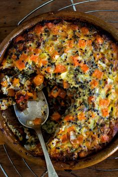 a casserole with carrots and other toppings in a dish on a wire rack