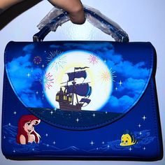 Loungefly X Disney The Little Mermaid Ariel Glow In The Dark Fireworks Crossbody Satchel Bag Purse Brand New With Tag Limited Edition On The Front Ariel & Flounder Delight In A New Discovery, A Ship That’s Bursting With Fireworks For Prince Eric’s Birthday Twinkling Stars In The Sky The Moon & Stars Glow In The Dark On The Back Features Sebastian Adjustable And Detachable Strap Flat Bottom Top Grab Carrying Handle Fold Over Flap With Magnetic Closure 10” X 7” X 3” Vegan Leather Matching Lining L Disney Blue Shoulder Bag For Travel, Blue Rectangular Bag For Disney Trips, Blue Disney Bags For Gifts, Themed Blue Bags For Gifts, Disney Evil Queen, Disney Fireworks, Ariel And Flounder, Disney Store Japan, Part Of Your World