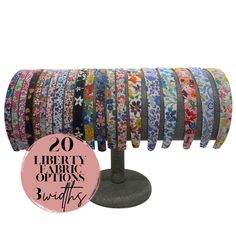 an assortment of liberty fabric strips on a stand