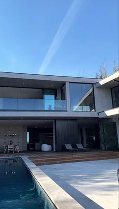 a modern house with a swimming pool in the foreground