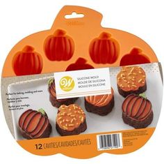 six cupcakes with frosting in the shape of pumpkins on an orange background