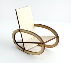 a wooden rocking chair sitting on top of a white table next to a book holder