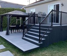 a house with a deck and gazebo in the yard