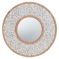 a white and wood circular mirror sitting on top of a table