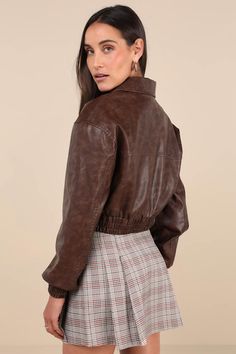 Hit the road looking cuter than ever in the Lulus Iconic Travels Brown Vegan Leather Cropped Bomber Jacket! Pebbled faux leather, with distressed fading throughout, shapes this stylish jacket with a collared neckline and long sleeves with drop shoulders and fitted elasticized cuffs. An exposed silver zipper secures at the front of the cropped bodice that boasts two, seamed zippered front pockets. Classic, elasticized banded hem completes the look. Pair with the matching skort for a complete look Trendy Collared Biker Jacket For Fall, Spring Collared Faux Leather Outerwear, Trendy Collared Biker Jacket For Spring, Trendy Brown Collared Leather Jacket, Trendy Collared Faux Leather Outerwear, Trendy Brown Cropped Jacket For Fall, Brown Collared Leather Jacket For Spring, Trendy Faux Leather Collared Jacket, Distressed Brown Leather Jacket For Fall