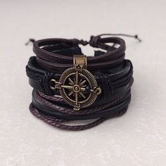 Embrace the allure of the unknown and showcase your adventurous side with our Multilayer Compass Pirate Bracelet. With its striking design and adjustable size, this accessory invites you to chart your own course in style. So, set sail on a journey of self-expression and discovery. Product Information *Set contains 3 separate bracelets *Adjustable length:       7 - 8.5 inches (fits most adults)      6 inches  *Metals Type: alloy *Materials: faux leather, leather *Adjustable: Sliding lock *Men's, Pirate Jewelry Bracelets, Pirate Accessories Aesthetic, Pirate Clothes Aesthetic, Pirate Accessories Women, Black Bracelet Jewelry For Outdoor, Black Outdoor Bracelet Jewelry, Vintage Adjustable Wristband Bracelet, Adjustable Vintage Wristband Bracelet, Adjustable Bohemian Jewelry For Outdoors