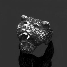 a silver ring with an animal head on it