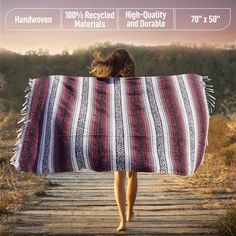 a woman walking down a path with a blanket over her head and the words handwoven