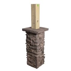 a tall brick pillar with a wooden post sticking out of it's center piece