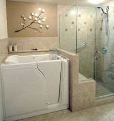 a bath tub sitting next to a walk in shower