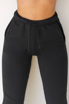 High-waist sweatpants with a relaxed fit and tapered silhouette. These comfy joggers feature side pockets, fitted ankle bands and an elastic waist with adjustable drawstring. Custom knit french terry fabric Brushed mid-weight cotton - ideal for layering Soft, comfortable and made to last Color: Black French Terry Sizing: X/S (0-2), S/M (4-6), M/L (8-10) Model is 5'8" and wearing size X/S Fabric: 100% Cotton Care: Machine Wash Cold With Like Colors.Care: Tumble Dry Low. JOAH BROWN | MADE IN LOS A Relaxed Fit Drawstring Sweatpants For Sportswear, Stretch Sweatpants With Drawstring In Sportswear Style, Stretch Sweatpants With Drawstring, Stretch Sweatpants With Drawstring For Sportswear, Cotton Drawstring Joggers Sportswear, Sportswear Lounge Pants With Drawstring, Sportswear Sweatpants With Drawstring For Loungewear, Solid Color Sportswear Sweatpants With Drawstring, Sportswear Joggers With Drawstring