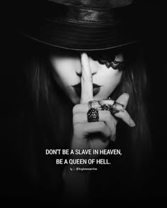 a woman wearing a hat and holding her finger up to her face with the words don't be a slave in heaven, be a queen of hell