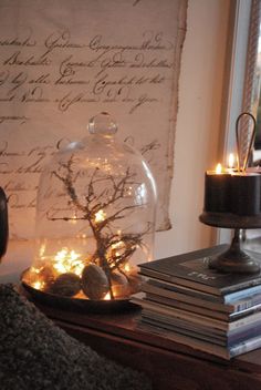 a table topped with a cake covered in frosting next to a lamp and books