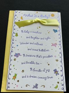 a card with a yellow ribbon on it that says, what is a baby?