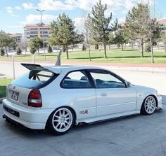 a white car is parked on the street