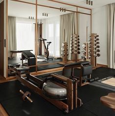 an exercise room with mirrors and machines in it