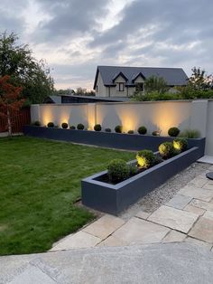 a modern garden with lights in the middle