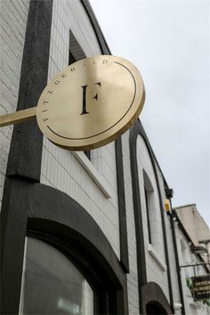 a clock on the side of a building with a sign that reads 1 o'clock