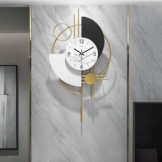 a clock that is on the side of a wall in a living room with marble walls