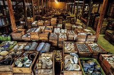 an old book store filled with lots of boxes full of books and knick knacks