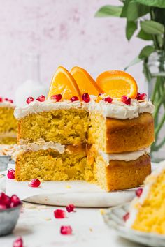 there is a cake with oranges on top and white frosting in the middle