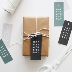 a gift wrapped in brown paper and tied with white twine next to some scissors