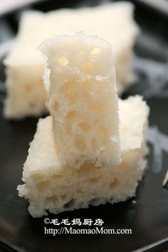 two pieces of cake sitting on top of a black plate