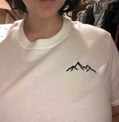 A unisex handmade 100% cotton t-shirt with a machine embroidered mountain design. A perfect top for anyone who loves the outdoors or adventures! Thank you for your support! Reach out with any questions or if you have a custom request. Mountain Design, Embroidery Tshirt, Mountain Tshirt, Mountain Designs, Embroidery Ideas, Embroidered Tshirt, Shirt Ideas, The Outdoors, Plein Air