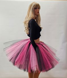 Make a statement and capture everyone's attention with this eye-catching Black, Shocking Pink, and Fuchsia Tutu Skirt. Designed to impress, this vibrant skirt is meticulously crafted by tying strips of tulle onto a highly stretchy elastic band, ensuring a comfortable and secure fit for all-day wear. Whether you're planning a family photoshoot, celebrating a birthday party, enjoying holidays, or simply seeking to add a touch of whimsy to your day, this tutu skirt is the perfect choice. Its vibrant colors of black, fuchsia, and shocking pink create a visually stunning contrast that will make you stand out from the crowd. For sizes 14 and above, this tutu skirt is 20 inches long, allowing for graceful movement and showcasing its vibrant colors. For smaller child sizes, the skirt is tailored t Pink Skirt For Spring Costume Party, Pink Tiered Tulle Mini Skirt, Pink Mini Skirt For Costume Party, Spring Pink Skirt For Dance, Fitted Pink Skirt For Dance, Multicolor Tiered Mini Skirt For Party, Pink Fitted Skirt For Costume Party, Fitted Pink Skirt For Costume Party, Party Multicolor Tiered Skirt