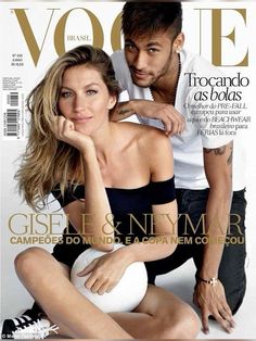 a man and woman sitting on the cover of a magazine, posing for a photo