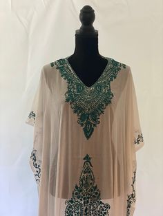 Embroidered Kashmiri Georgette Kaftan - One Size, Long. This Kaftan makes a perfect style statement for summer and your beach vacation. This is a bohemian style maxi dress that can be perfect as a swim coverup or for your beach vacations. Color: White with Green Embroidery Fits small to plus sizes. Measurements with room for comfort: Chest up to: 50 inches Length: 55 inches Care: Hand wash or dry clean only. Embroidered Kaftan For Beach Cover-up, V-neck Embroidered Maxi Dress For Summer, Summer V-neck Tunic With Chikankari Embroidery, Traditional V-neck Maxi Dress For Summer, Spring V-neck Kaftan With Chikankari Embroidery, Spring Festival Kaftan With Chikankari Embroidery, Bohemian Beige Kaftan For Beach Cover-up, Summer V-neck Embroidered Kaftan, Spring Embroidered Beachwear Maxi Dress