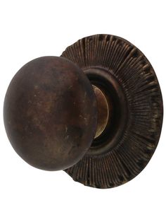 an old door knob with a round design on the front and back side, isolated against a white background