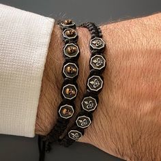 Bold and stylish men won't want to miss out on this! This bracelet can go with any outfit and is sure to elevate your style to the next level. It's perfect for layering with other bracelets as well. 925 Sterling Silver Fleur De Lis symbols give an elegant look to this bracelet.Details;Black jewelry ropeHandmade 925 Sterling Silver Fleur De Lis CharmsSliding Clasp Closure adjustable sizeHandmade in USA Avoid contact with chemicals, makeup, parfume. Do not use dips or abrasive cleaners on bracelet Jewelry Rope, Unique Mens Bracelet, Weird Jewelry, Man Weave, Wrist Wear, Woven Bracelet, Men Bracelet, Black Rope, Black Skull