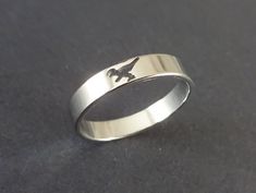 This listing is for a beautiful silver color Stainless Steel dinosaur band. The stylish ring features a classic silver color with a cut out dinosaur design. This ring comes in US sizes 7-10.  Type- Ring Sub-Type- Stainless Steel Ring Style- Classic, Minimalist, Simplistic  Size- Adjustable/Resizable  Accents- Dinosaur cut out shape Metal Type- Stainless Steel Color- Silver Why should you shop with Beadology By Heather? -We have a large amount of premium beads and supplies that we offer with your Dino Ring, Masculine Rings, Dinosaur Cut Outs, Dinosaur Ring, Dinosaur Jewelry, Animal Ring, Cut Out Shapes, Animal Rings, Dinosaur Design