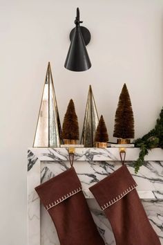 christmas stockings hanging on the mantel in front of a fireplace